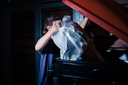 Man and van team loading bulky items from a shop on a busy street